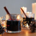 German Mulled Wine Gluhwein surrounded by pine cones, candles and lights