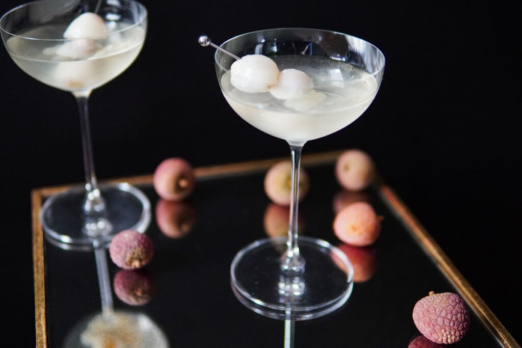 Lychee Martini on mirror with fresh lychees