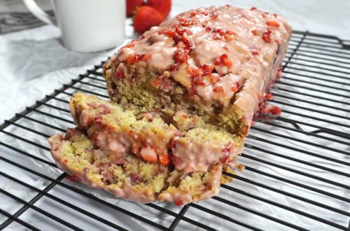 Sliced Strawberry bread with glaze on a cooling rack