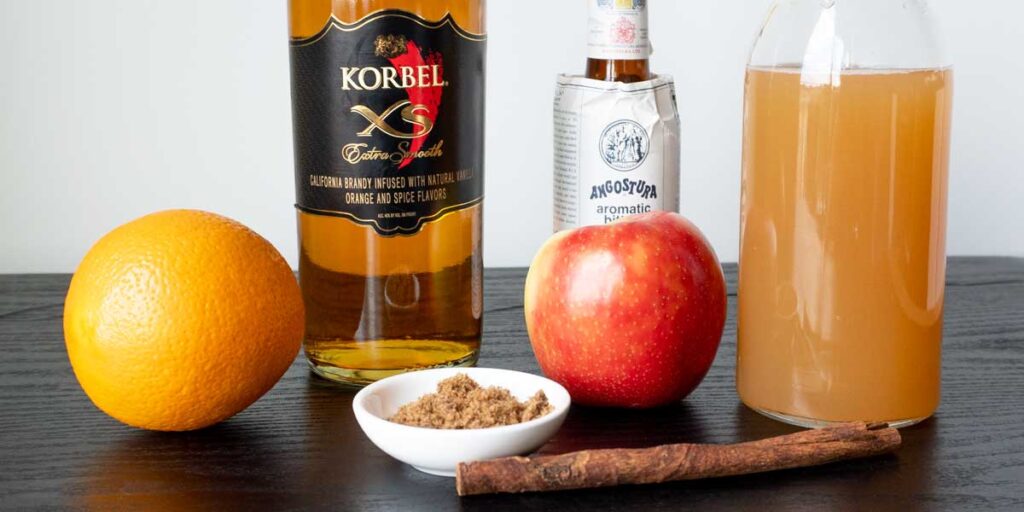 Apple Cider, Brandy, Bitters, Brown Sugar, Orange, Apple and Cinnamon Stick to make Apple Cider Old Fashioned