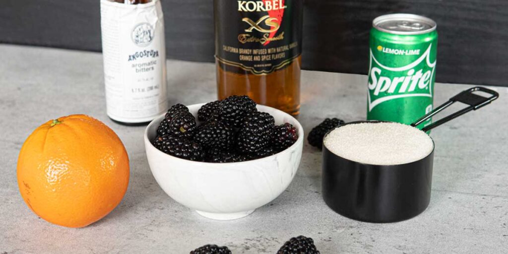 Blackberry Old Fashioned Ingredients: Blackberries, sugar, orange, sprite, bitters and brandy