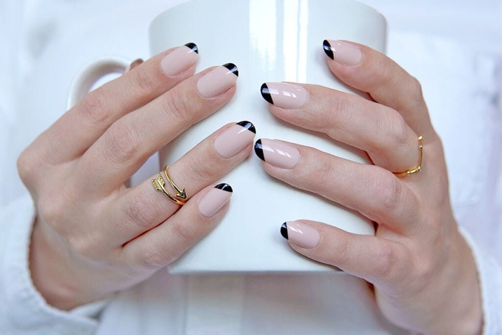 Marmalade Nails in Splice on hands holding a white mug
