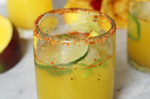 Spicy Mango Mocktail with Tajin Rim and Roses in background