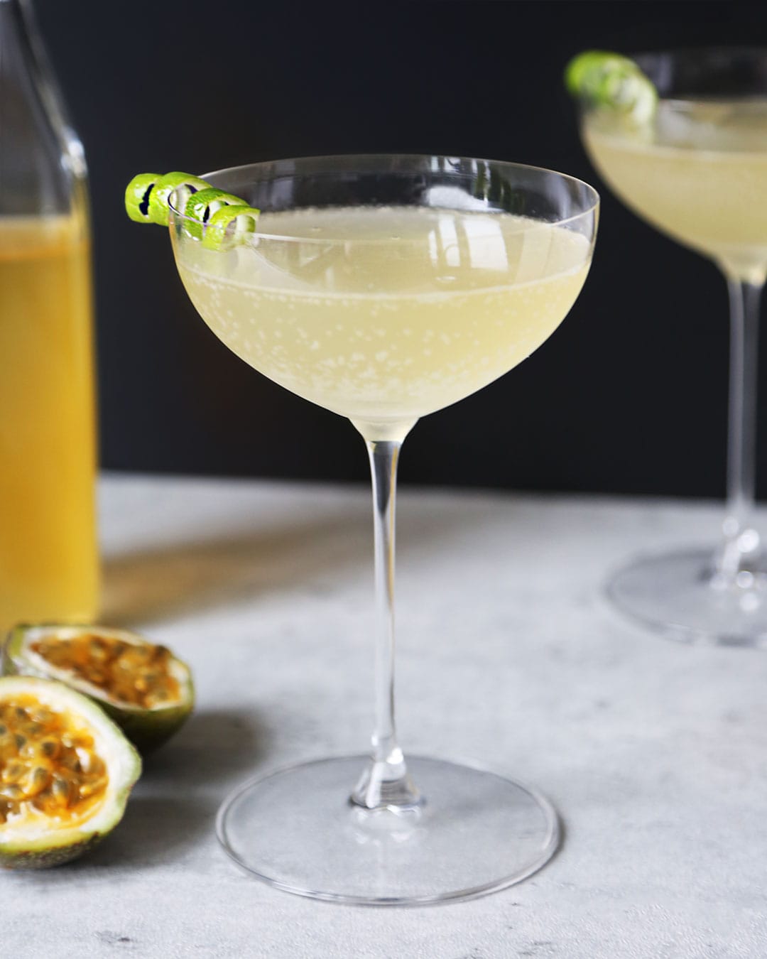 Passion Fruit Martini in Coupe Glass with Black Background