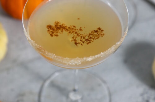 Pumpkin Spice Chai Martini in Coupe Glass with Mini Pumpkins