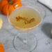 Pumpkin Spice Chai Martini in Coupe Glass with Mini Pumpkins