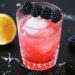 blackberry ginger cocktail in waterford dof glass on black marble table