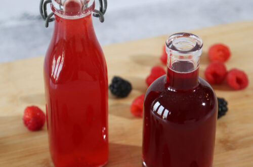 Raspberry Simple Syrup and Blackberry Simple Syrup in glass bottles