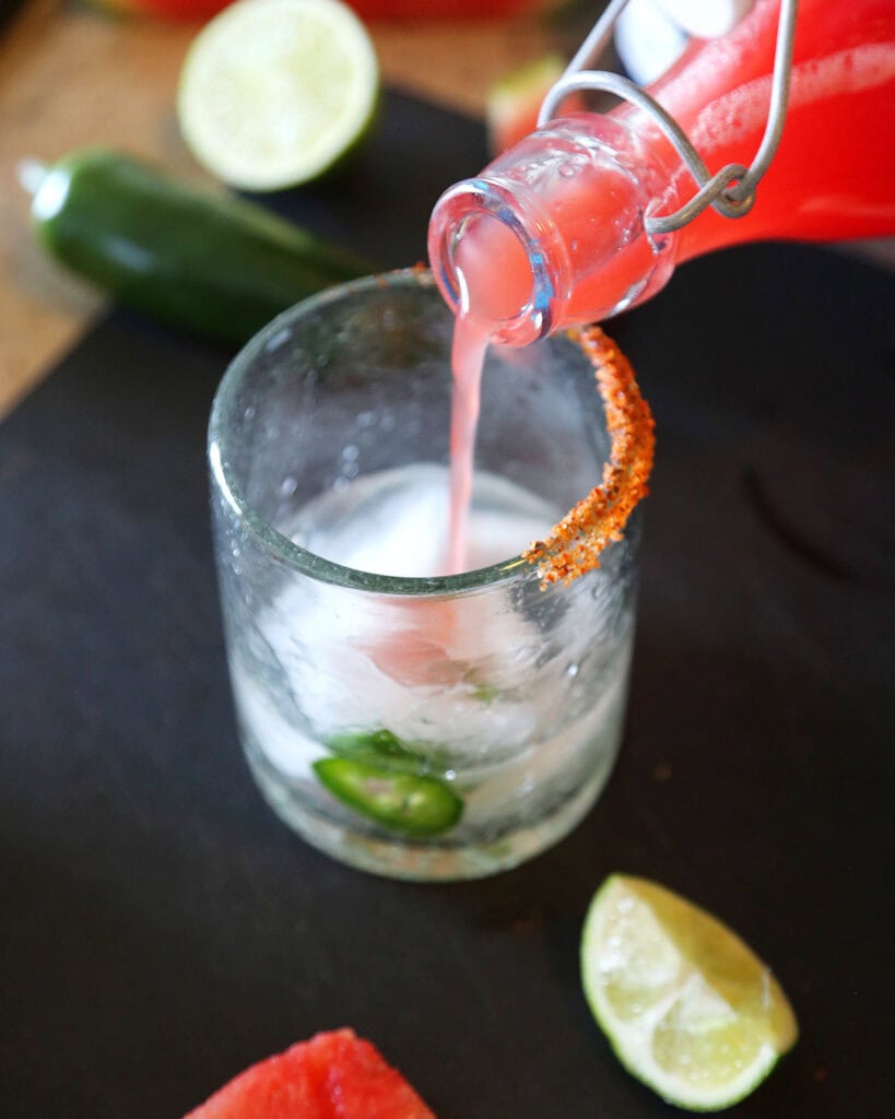 Spicy Watermelon Margarita, pouring in Watermelon Water with Tequila and Fresh Jalapenos